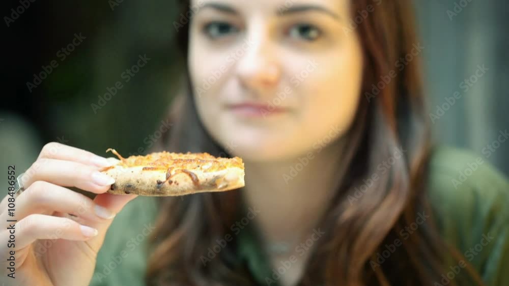 Pretty girl sitting in the restaurant and eating pizza
Pretty girl sitting in the restaurant and eating pizza