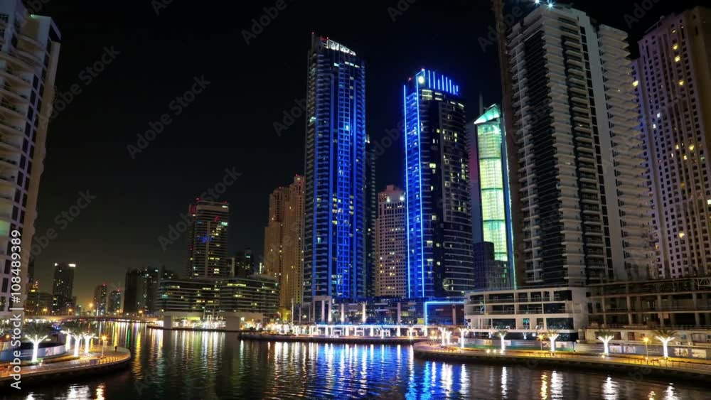 Dubai Marina night time lapse, United Arab Emirates. Dubai Marina - the largest man-made marina in the world. Dubai Marina is a canal city, carved along a 3 km stretch of Persian Gulf shoreline, UAE Dubai Marina night time lapse, United Arab Emirates. Dubai Marina - the largest man-made marina in the world. Dubai Marina is a canal city, carved along a 3 km stretch of Persian Gulf shoreline, UAE