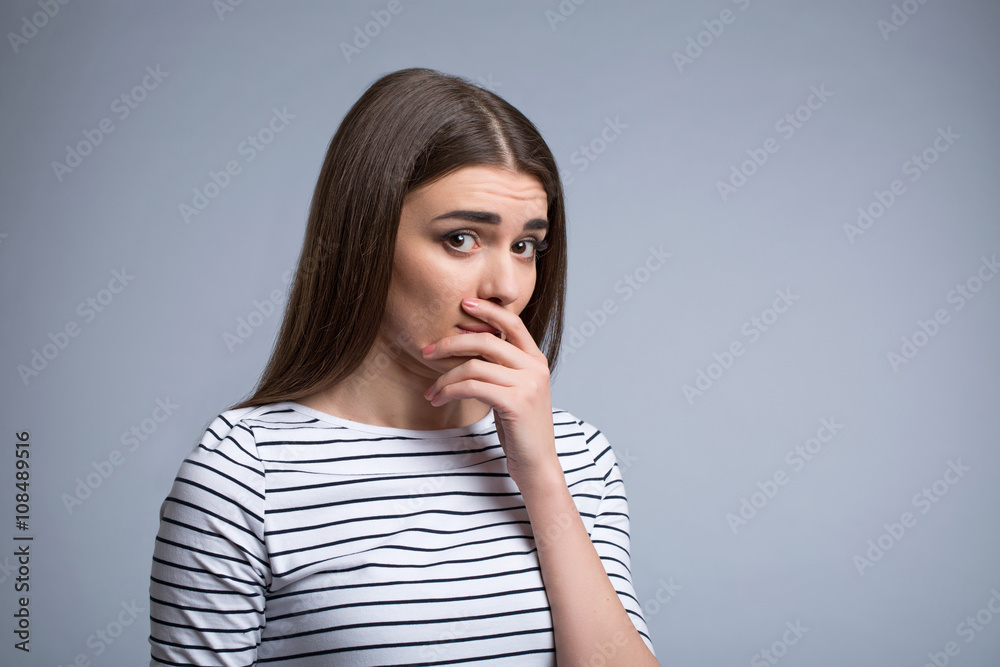 Nice girl closing her mouth with hand Nice girl closing her mouth with hand