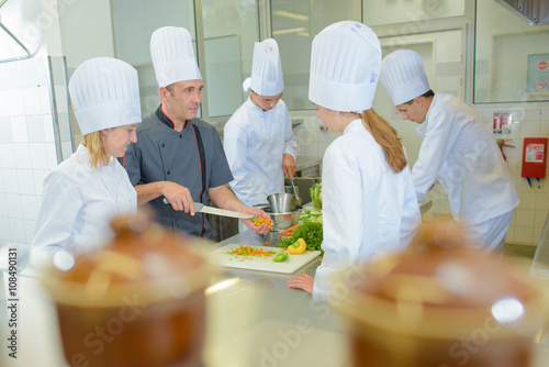 Fényképezés Chef teaching students on cookery course