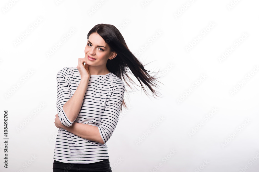 Pleasant girl standing isolated on grey background Pleasant girl standing isolated on grey background
