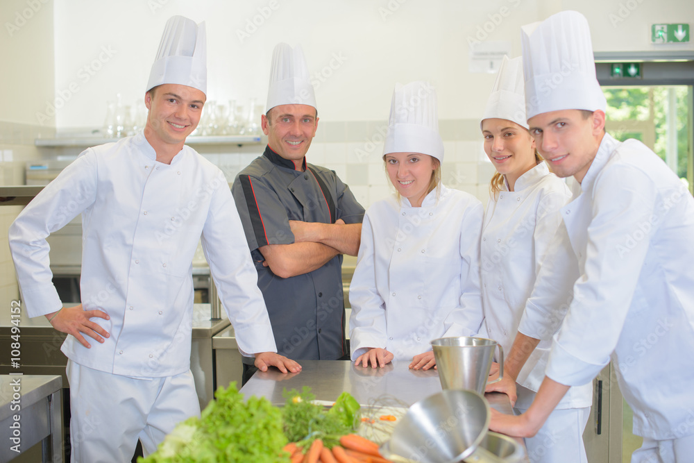 Portrait of chef with his student chefs