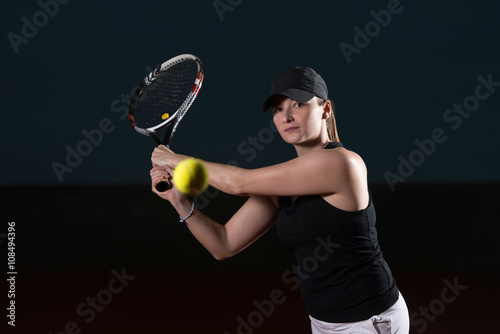 Tennis Player Hitting Tennis Ball © Jale Ibrak