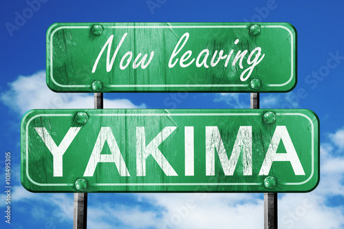 Leaving yakima, green vintage road sign with rough lettering photo