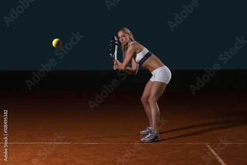 Tennis Player Hitting Tennis Ball