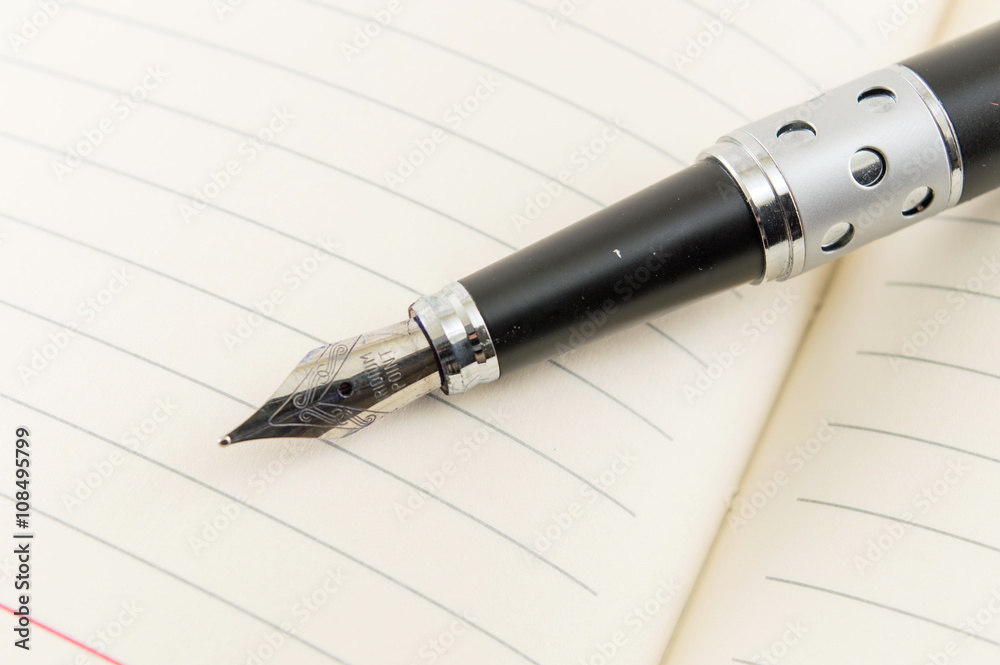 Black fountain pen on a notebook Black fountain pen on a notebook