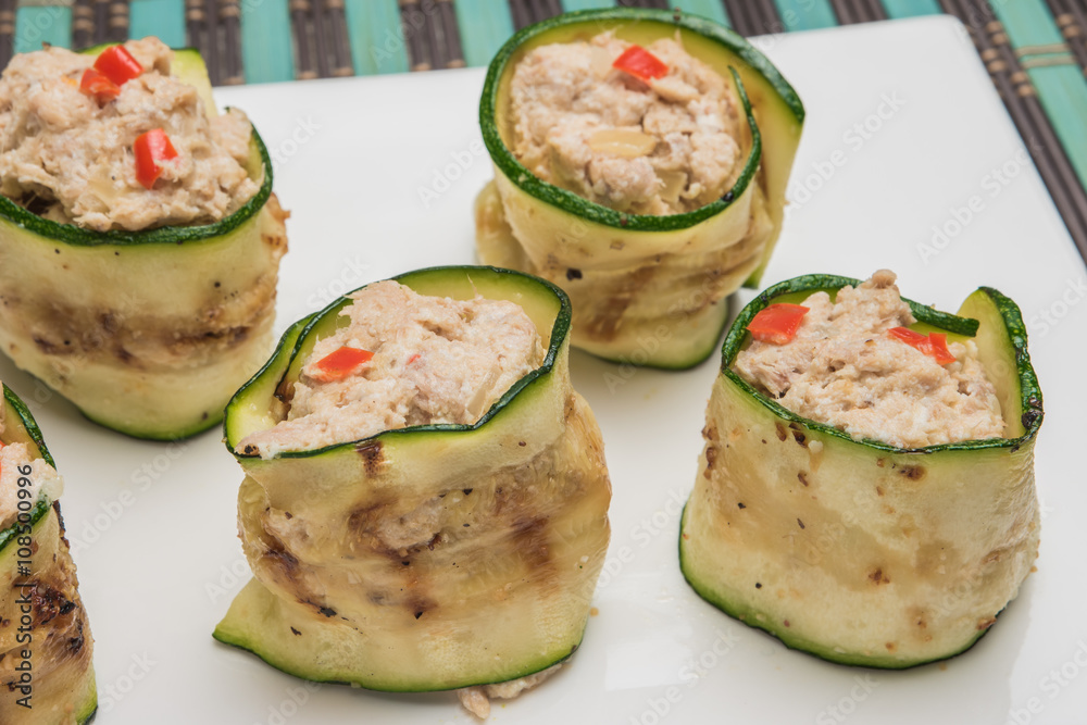 Grilled zucchini rolls with curd cheese and tuna on plate. Grilled zucchini rolls with curd cheese and tuna on plate.