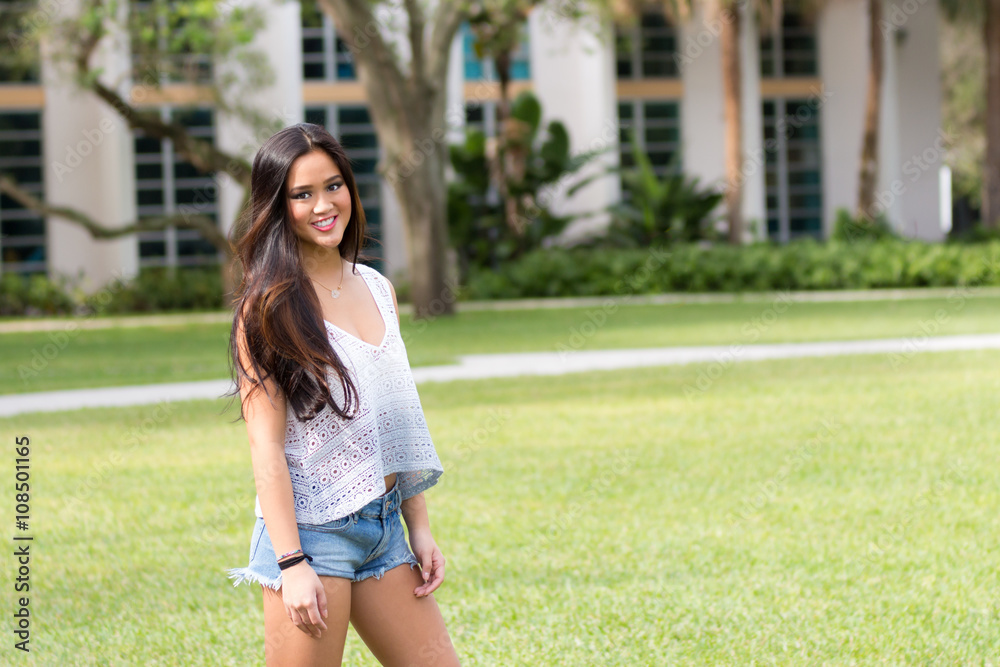 Portrait of a casual smiling young pretty Asian girl outdoors Portrait of a casual smiling young pretty Asian girl outdoors