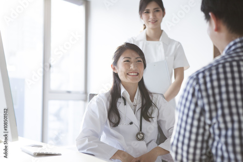 Female doctors are interview to the patient in the examination room photo