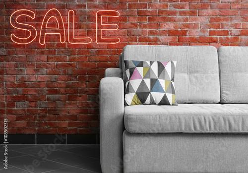 Sale concept. Grey sofa aga...