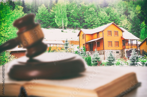 Valokuvatapetti Gavel and book on wooden table on building background