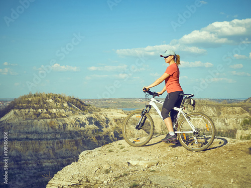 Fototapeta Naklejka Na Ścianę i Meble -  Girl  a bike in mountains.