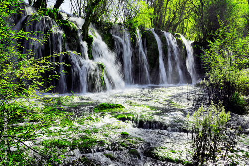 Fototapeta Naklejka Na Ścianę i Meble -  Beautiful waterfall with crystal clear water among green forest