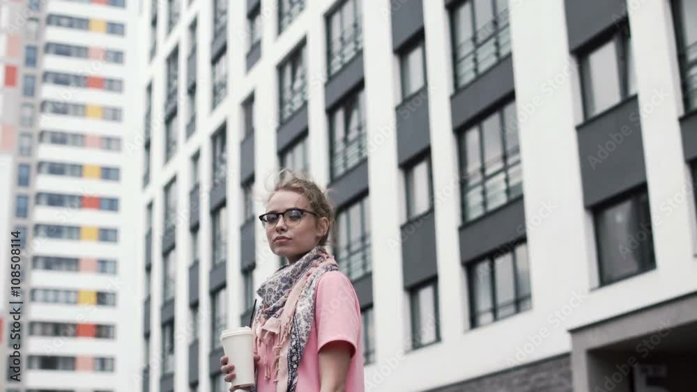 Young woman drinking coffee in the city. smiling and looking at the camera Young woman drinking coffee in the city. smiling and looking at the camera