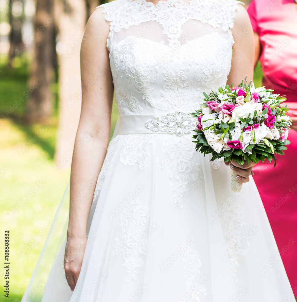 Wedding flowers ,Woman holding colorful bouquet with her hands on wedding day Wedding flowers ,Woman holding colorful bouquet with her hands on wedding day