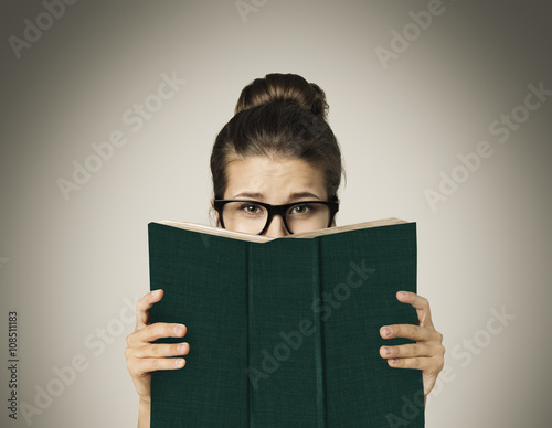 Open Book Hiding Face, Woman Eyes Reading in Glasses on Gray