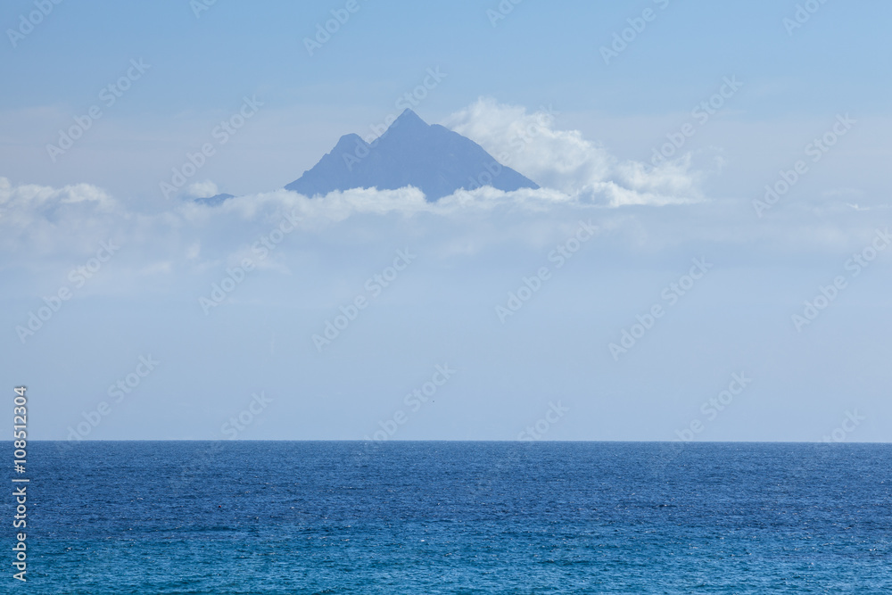 Peak of holy mountain Athos above the clouds