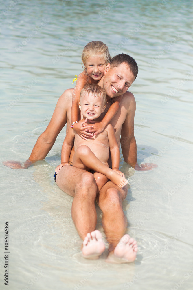 Father and son and daughter in the water Father and son and daughter in the water