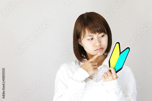 初心者マークを持つ女性