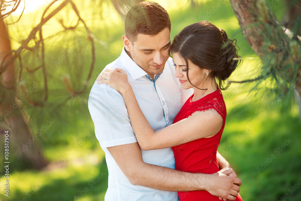 Fototapeta premium Happy young couple embrace in park