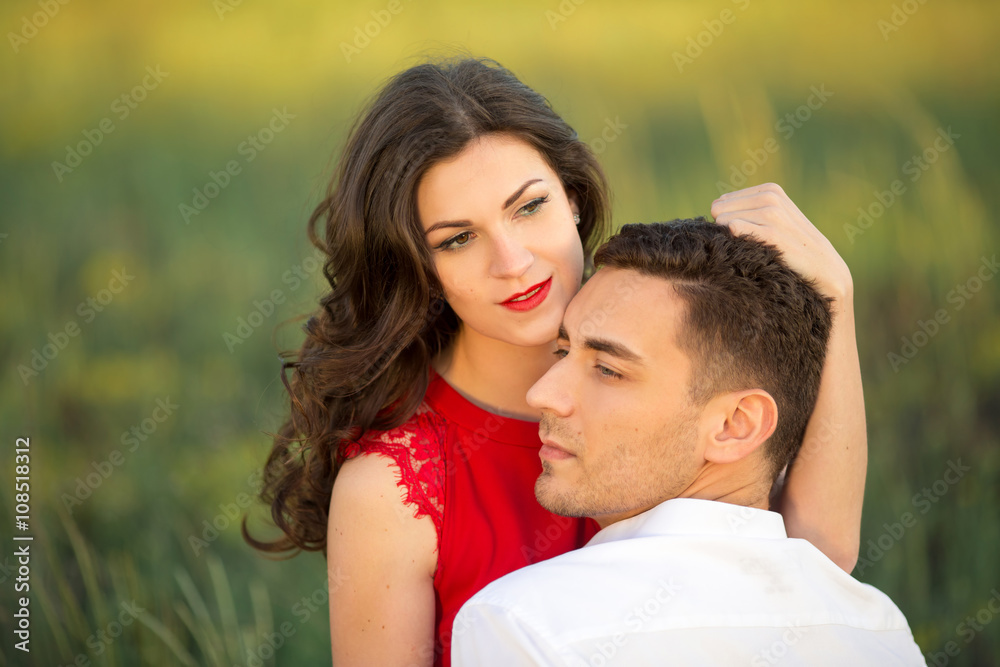 Happy young couple embrace in park Happy young couple embrace in park