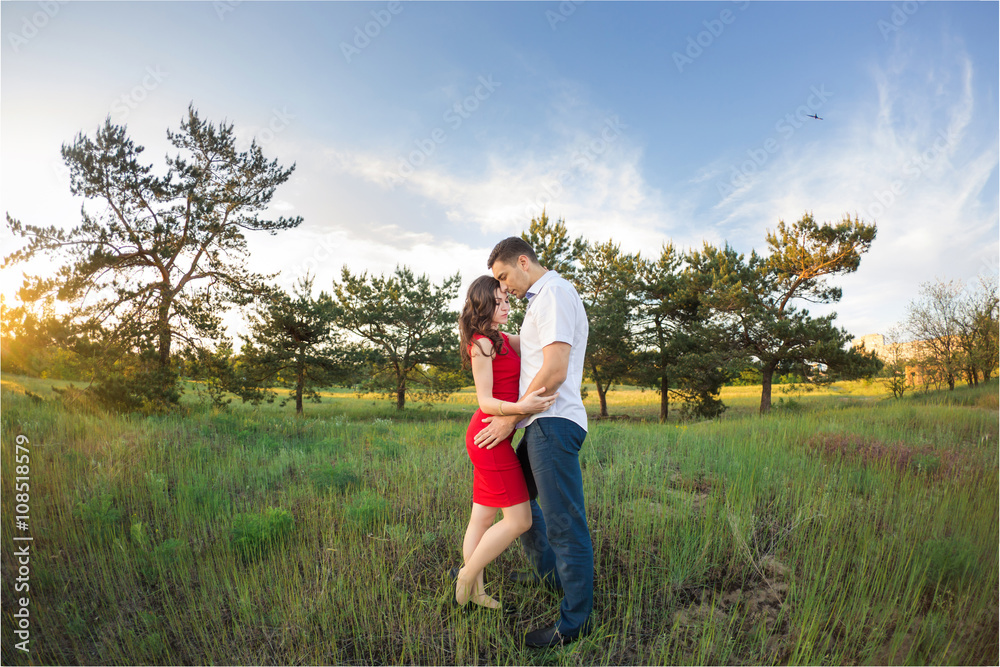 Happy young couple embrace in park