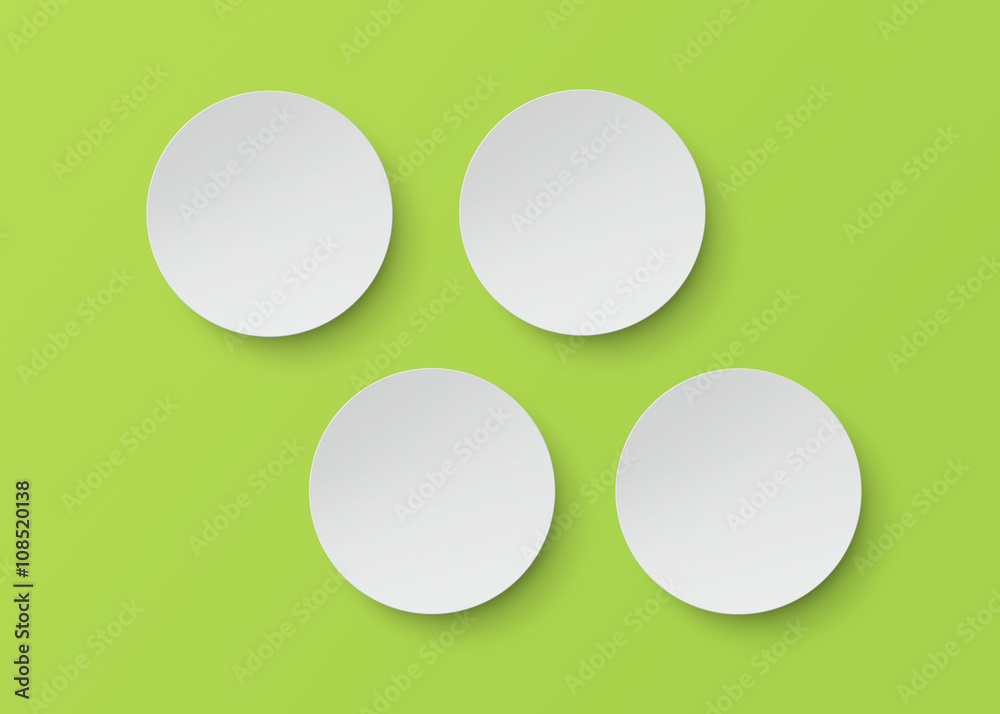 four white plate on green background with clipping path. four white plate on green background with clipping path.