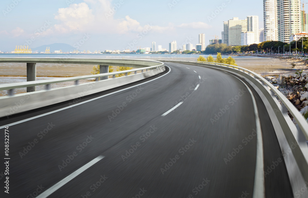 Highway overpass motion blur with city background .