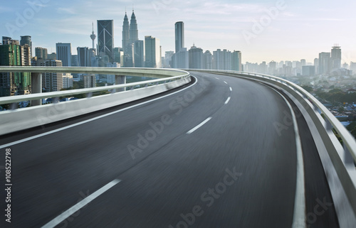 Highway overpass motion blur with city background . © jamesteohart