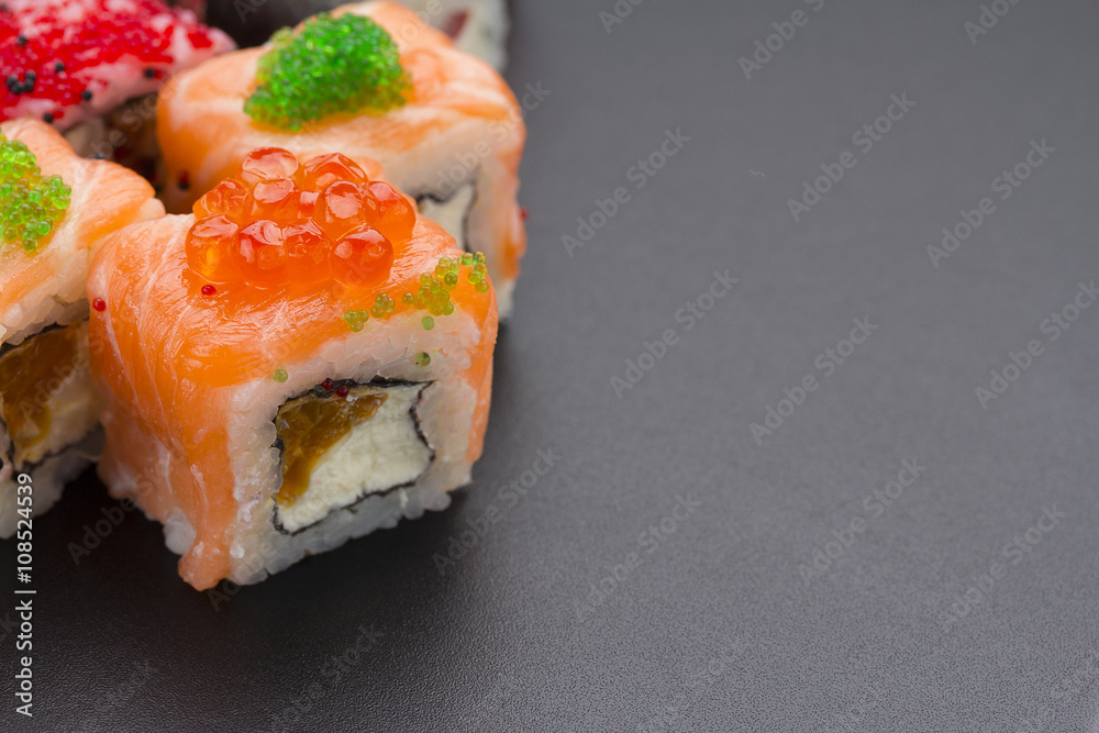 Japanese cuisine. Set of sushi mix roll with differen fresh ingredients over black background ( table ). Japanese cuisine. Set of sushi mix roll with differen fresh ingredients over black background ( table ).