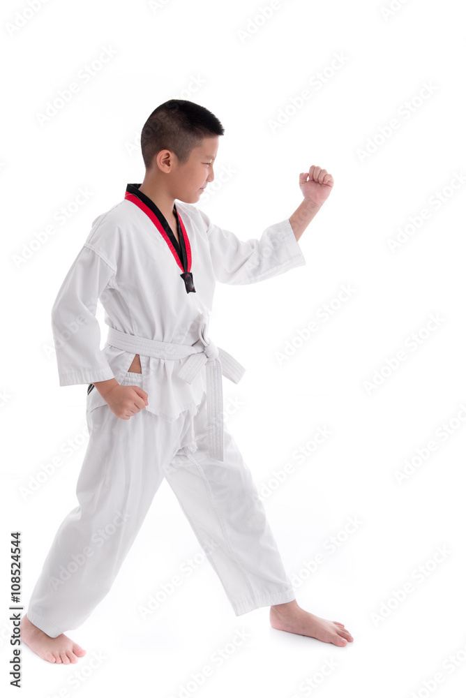 Young boy training taekwondo action isolated Young boy training taekwondo action isolated