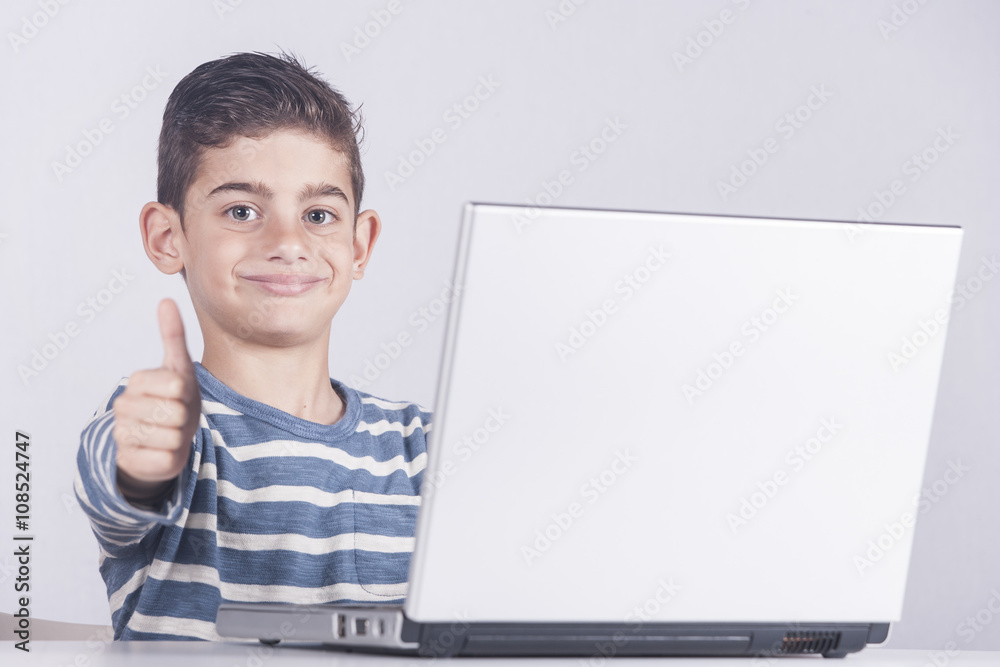 Young boy using a laptop computer (e learning concept) Young boy using a laptop computer (e learning concept)