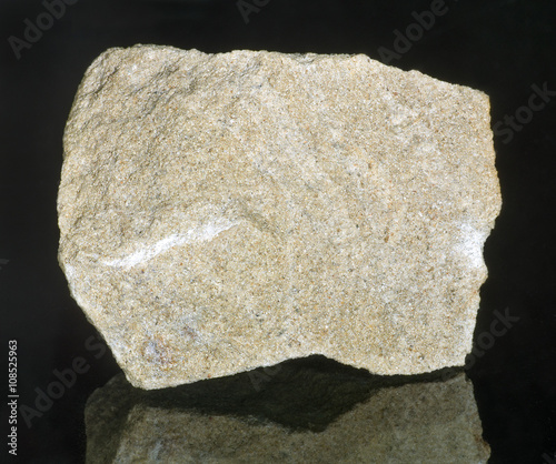 Mineral stone - sandstone. Most sandstone is composed of quartz and/or feldspar because these are the most common minerals in the Earth's crust.  photo