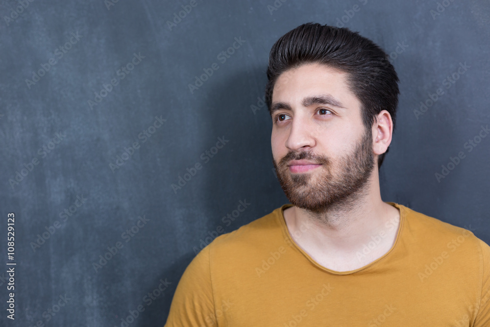 Attractive young man against blackboard. Attractive young man against blackboard.