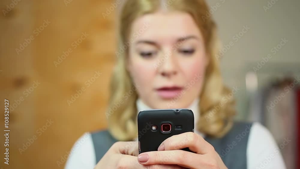 Cheerful lady chatting with boyfriend on her cellphone, browsing dating websites Cheerful lady chatting with boyfriend on her cellphone, browsing dating websites