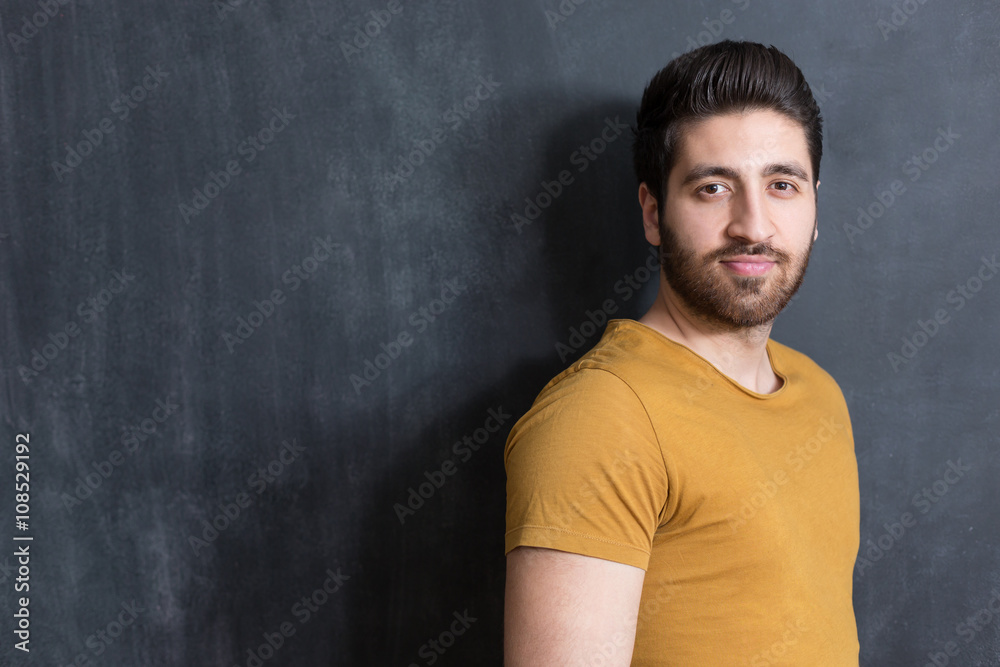 Handsome young man smiling on black background. Studio shot. Handsome young man smiling on black background. Studio shot.
