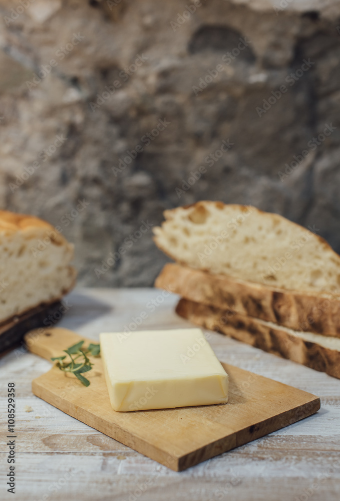 Pieces of rustic round loaf bread with butter