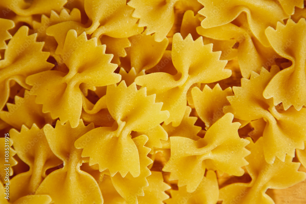 Beautiful background made of pasta ribbons on parchment paper Beautiful background made of pasta ribbons on parchment paper