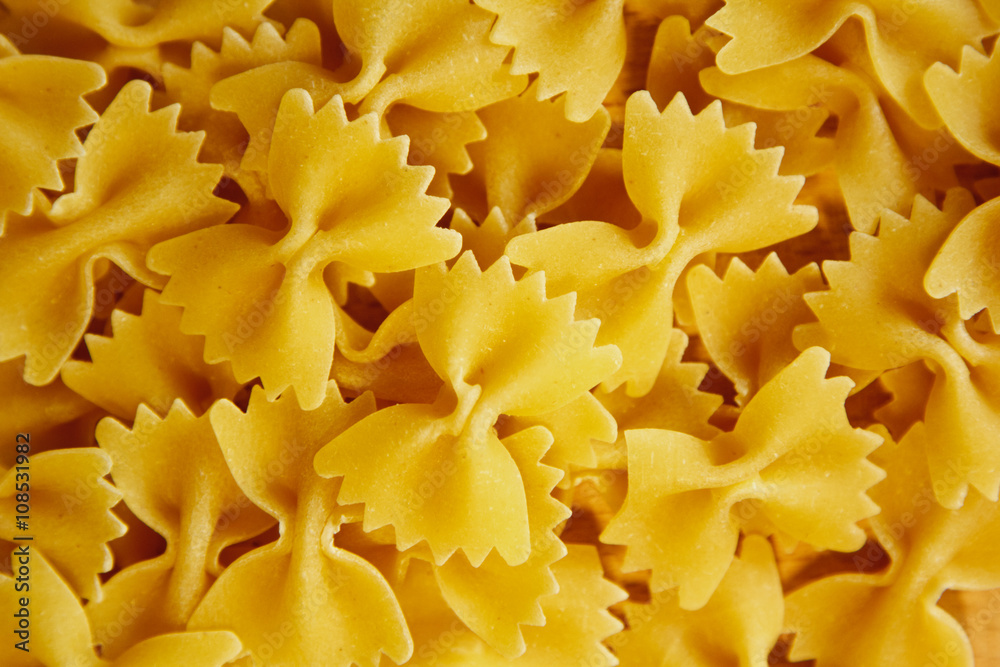 Beautiful background made of pasta ribbons on parchment paper Beautiful background made of pasta ribbons on parchment paper