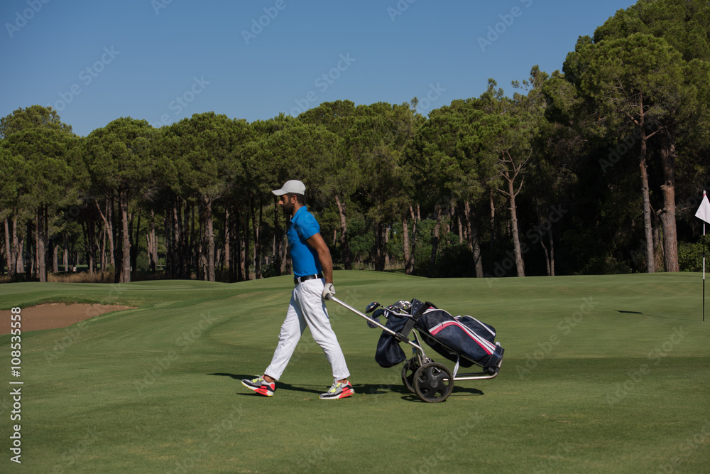 golf player walking with wheel bag golf player walking with wheel bag