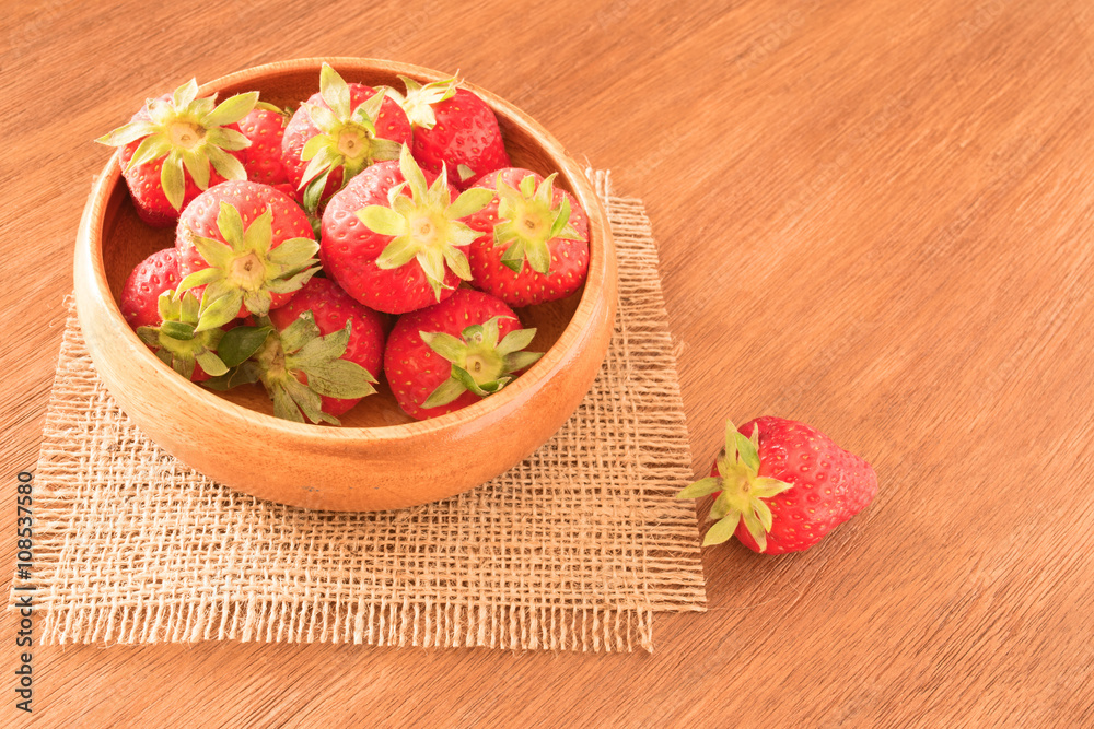 Strawberries in cup on wooden background Strawberries in cup on wooden background