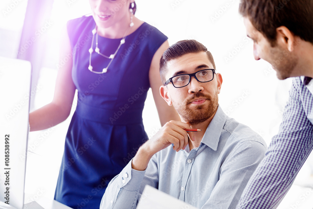 Attractive office worker sitting at desk Attractive office worker sitting at desk