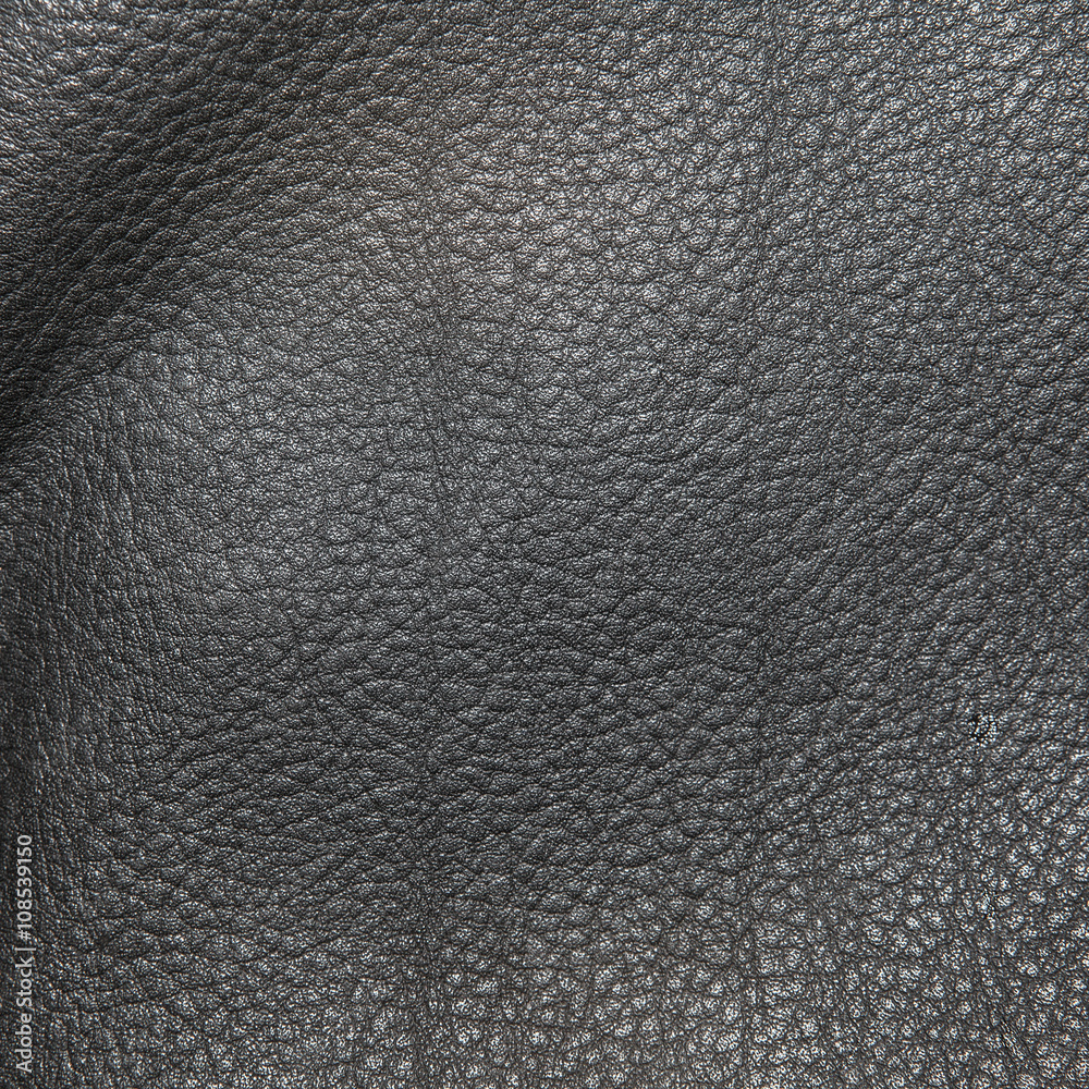 Black leather background in the folds Black leather background in the folds