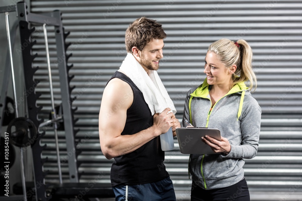 Fototapeta premium Smiling fit couple taking notes 