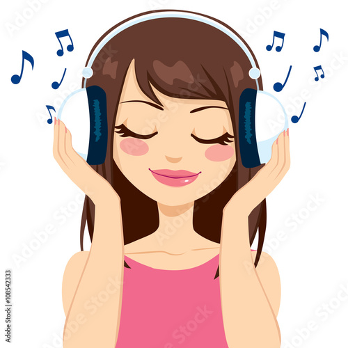 Beautiful brunette woman listening to music with white earphones