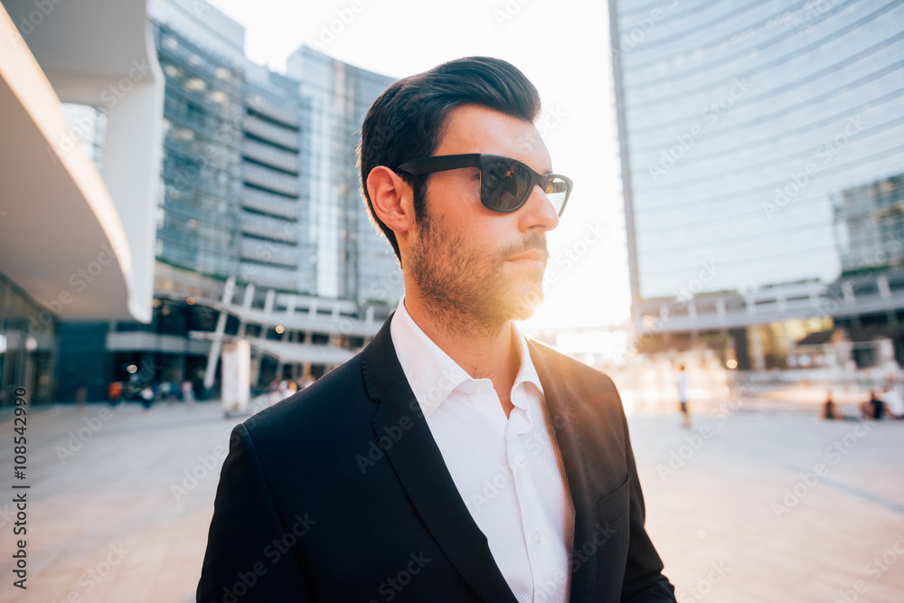 Half length of young handsome black hair modern businessman posing in the city back light, overlooking - successful, business, working concept