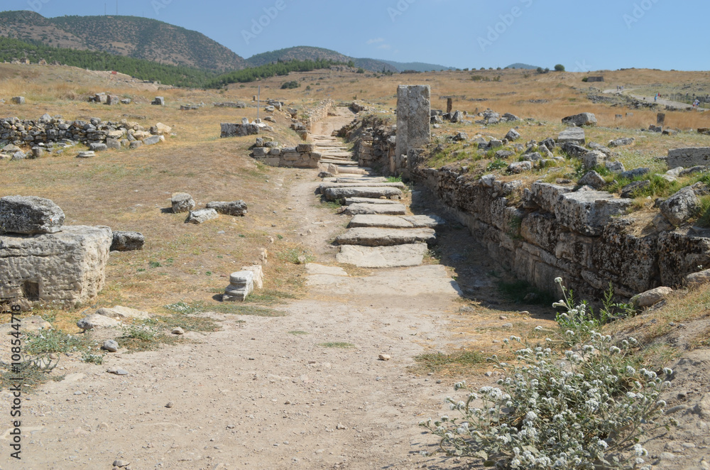 Scattered rocks of ancient ruins on a hill on archeological site of Hierapolis, central Turkey, Pamukkale 
