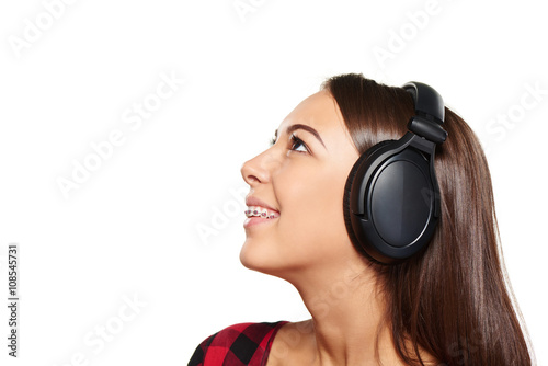 Female listening enjoying music in headphones