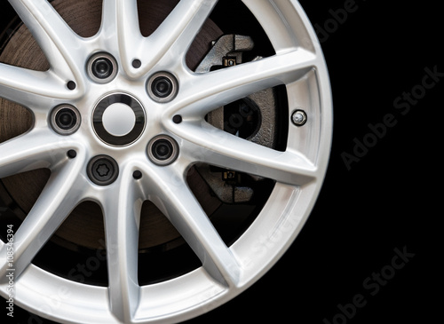 Silver modern car wheel on black background