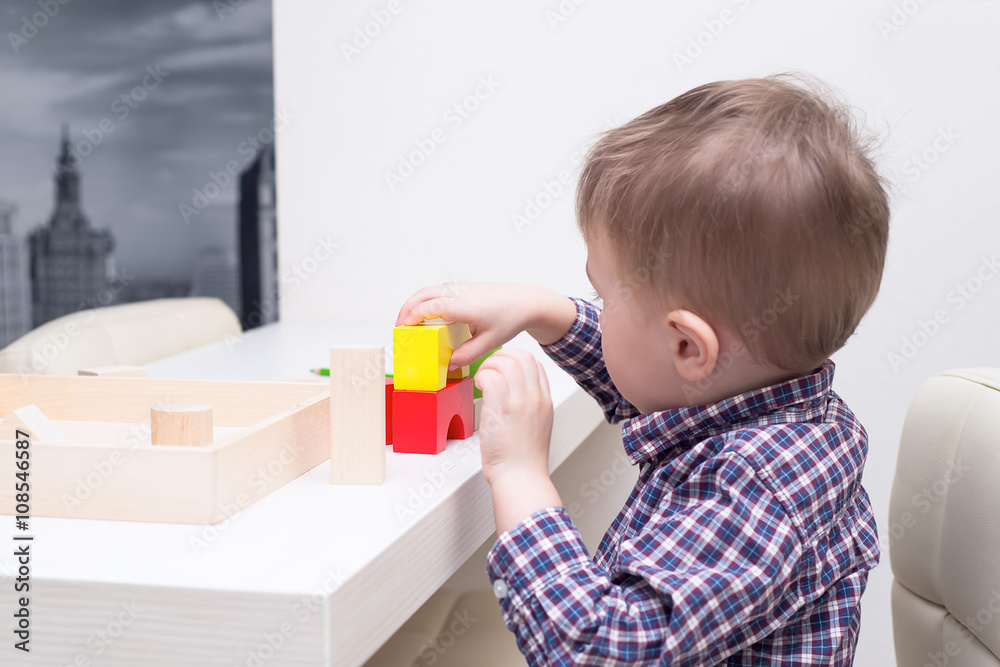 baby playing with wooden blocks at the table baby playing with wooden blocks at the table